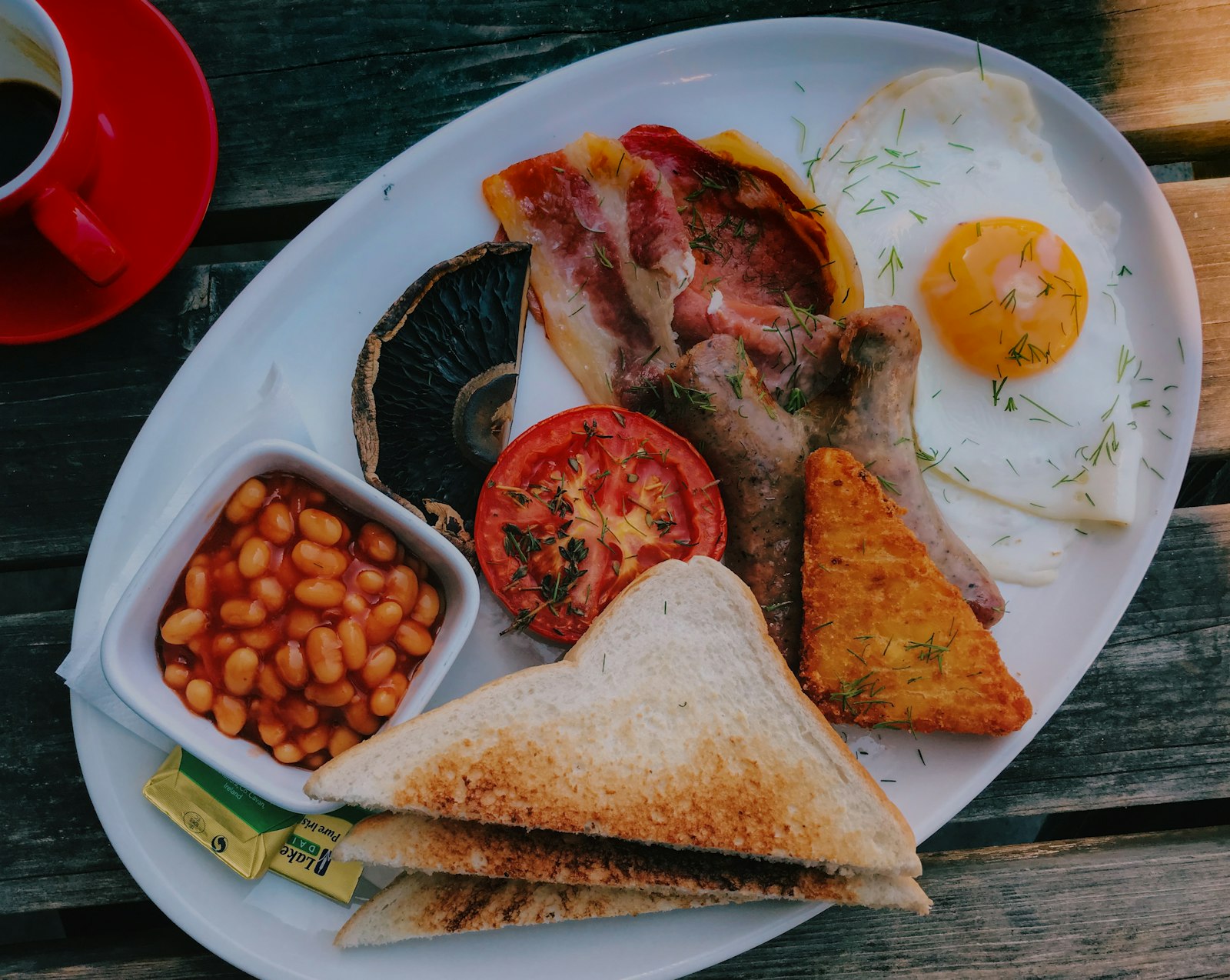 A full breakfast with fried eggs, bacon, beans and toast