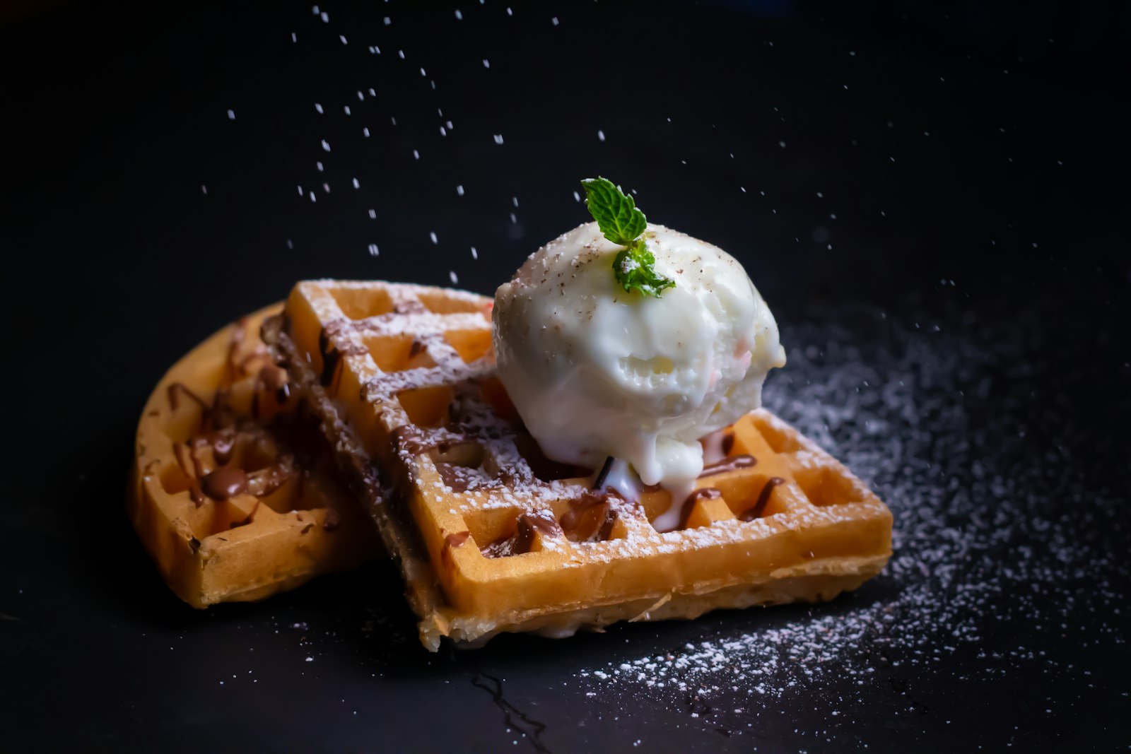 A Belgian waffle with a scoop of ice cream