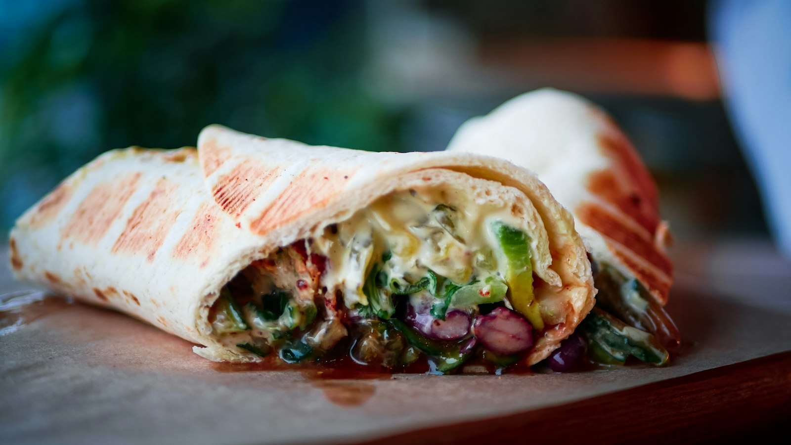 Two filled tortilla wraps in a bowl