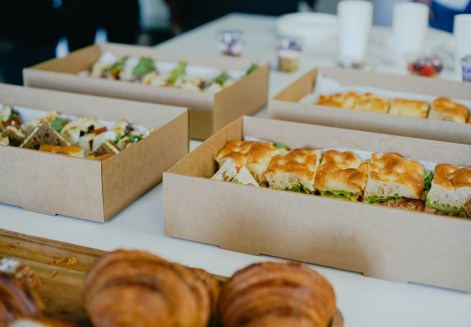 Boxes of sandwiches and pastries set out for a meeting
